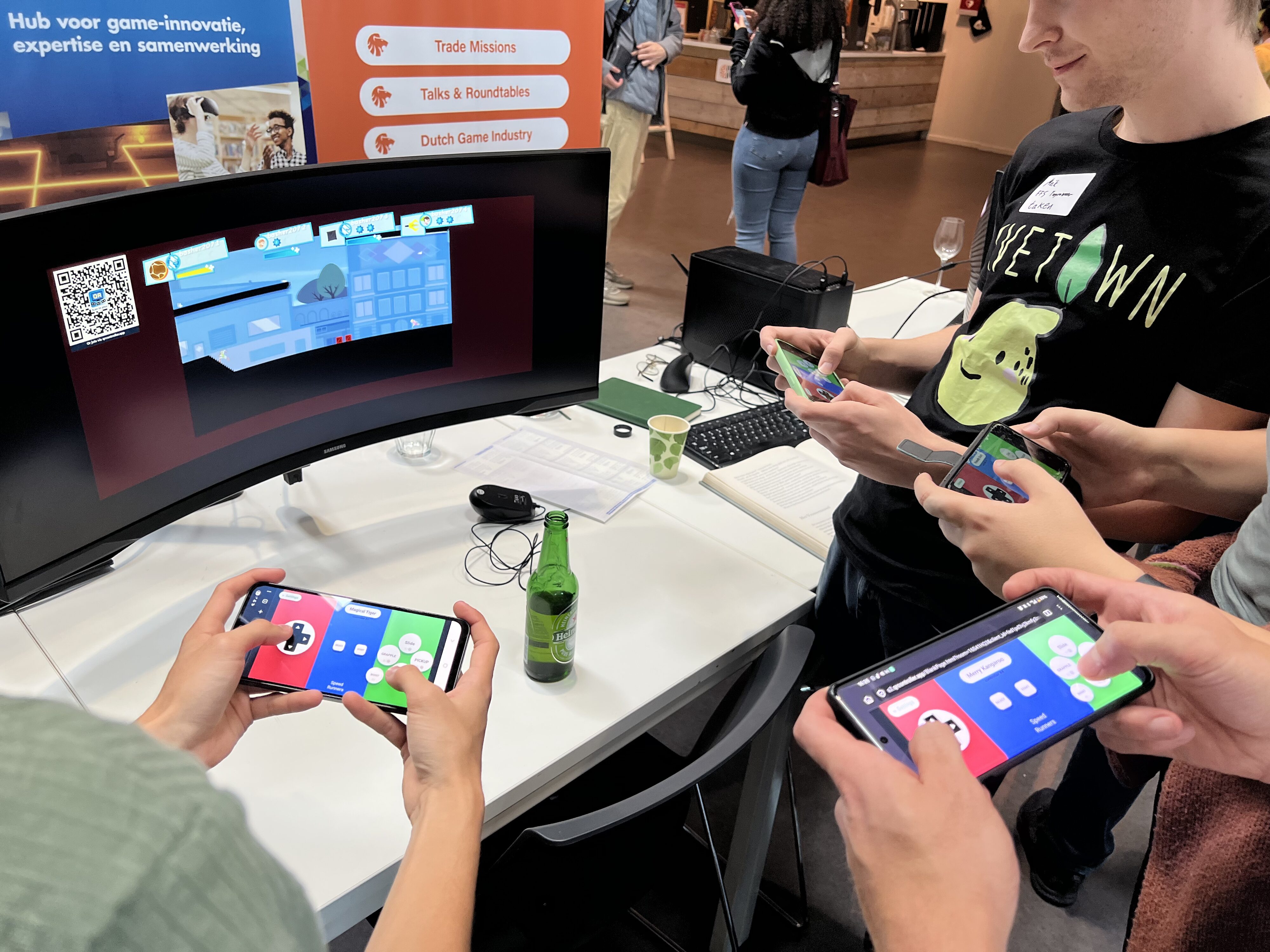 Friends playing Speedrunners game on their phones using QR Controller